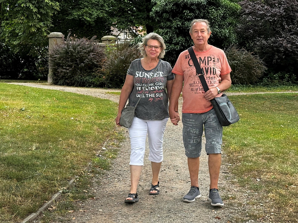 Siegfried Wagner und seine Frau gehen Hand in Hand auf einem Parkweg.